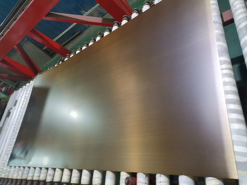 Brushed brass stainless steel wall panels in a modern office lounge setting